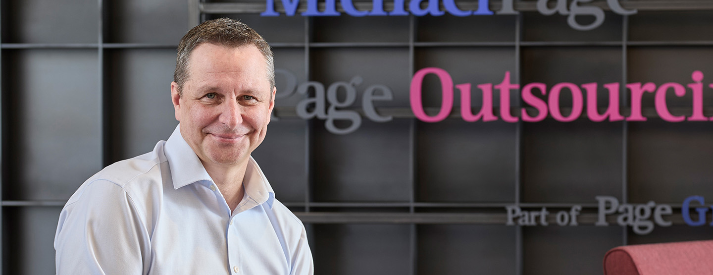 Kelvin Stagg in front of the PageGroup sign Kelvin Stagg in front of the PageGroup sign