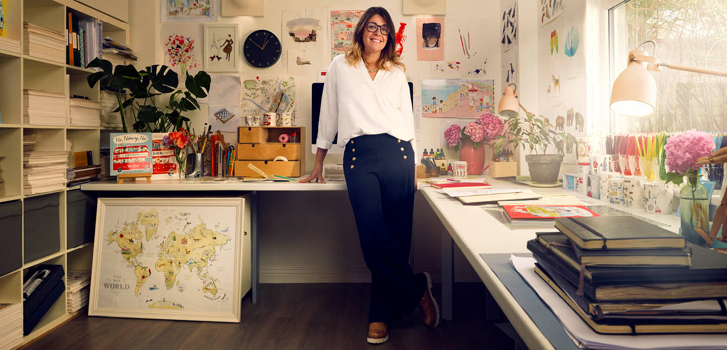 Alice stood in the middle of her studio, surrounded by illustrations. Alice stood in the middle of her studio, surrounded by illustrations.