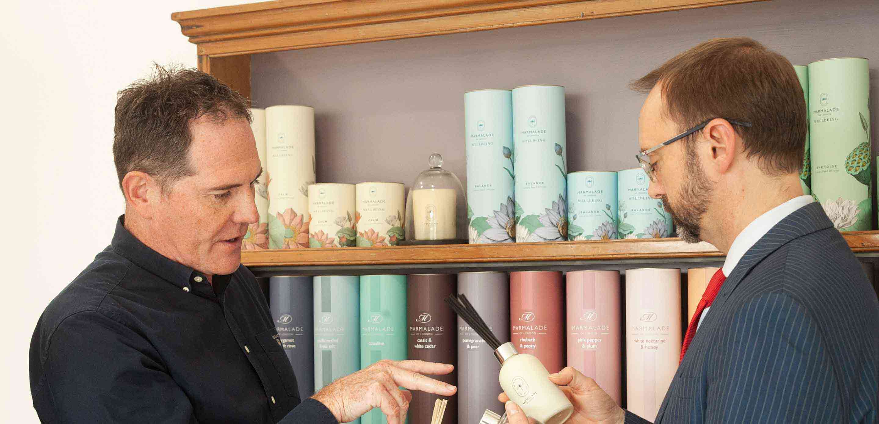 Two men looking at home fragrance products