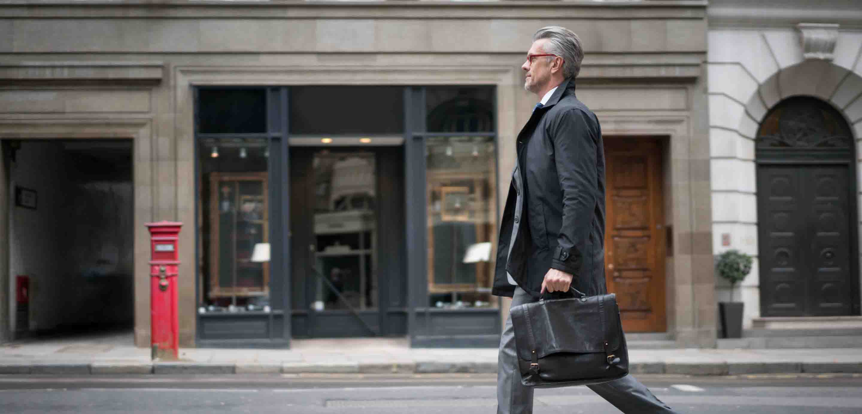 Businessman walking down a street with a briefcase  