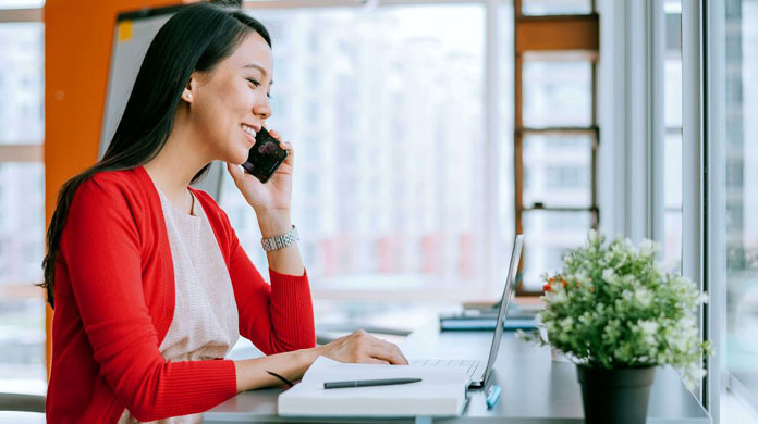 Lady in red cardigan working at laptop Lady in red cardigan working at laptop