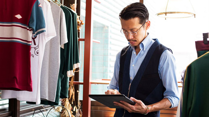 Man in clothing shop with tablet Man in clothing shop with tablet
