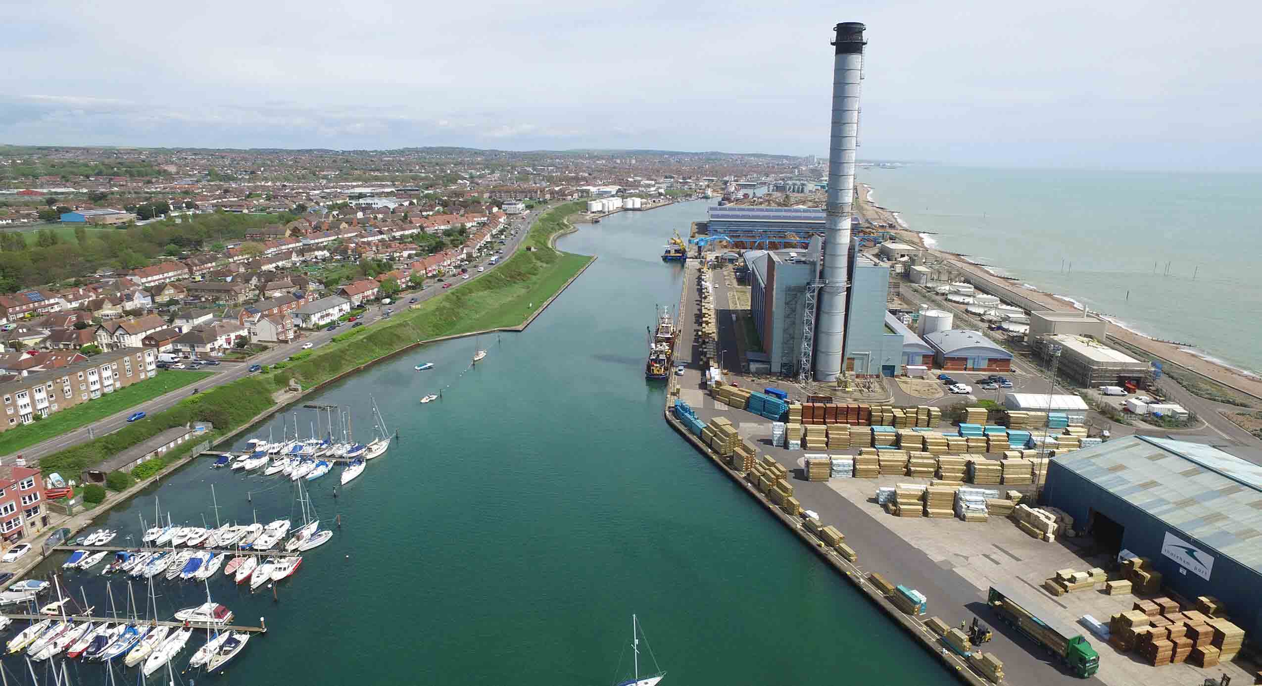 Port with boats and houses to the left and cargo to the right Port with boats and houses to the left and cargo to the right