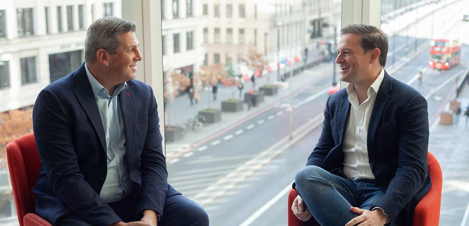 two men smiling in business meeting