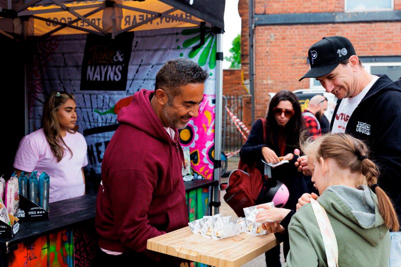 Jake Karia and customers at a food stall