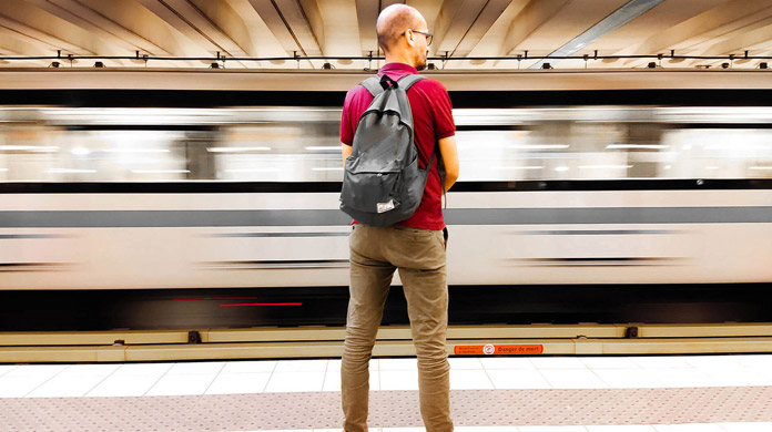 Main in red shirts on train platform Main in red shirts on train platform